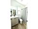 Bathroom featuring a large mirror over the vanity with sink and toilet and a standup shower at 6437 N 17 St, Phoenix, AZ 85016