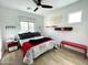 Bright bedroom featuring a modern ceiling fan, stylish decor, and a comfortable bed with decorative pillows at 6437 N 17 St, Phoenix, AZ 85016