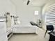 Bedroom with large windows with blinds, bed in center of room and office desk with chair to right at 6437 N 17 St, Phoenix, AZ 85016