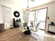 Bright dining room featuring a modern light fixture, round table and sliding glass door to the backyard at 6437 N 17 St, Phoenix, AZ 85016