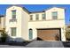 Inviting two-story home featuring a well-manicured lawn, arched door and a two car garage at 6437 N 17 St, Phoenix, AZ 85016
