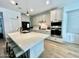 Modern kitchen featuring an island with seating, stainless steel appliances, and white cabinetry at 6437 N 17 St, Phoenix, AZ 85016