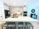 Modern kitchen featuring an island with seating, stainless steel appliances, and white cabinetry at 6437 N 17 St, Phoenix, AZ 85016
