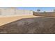 Large backyard with block wall and sandy ground at 16006 W Cottontail Ln, Surprise, AZ 85387