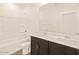 Bathroom boasts double sinks and a shower/tub combo at 16006 W Cottontail Ln, Surprise, AZ 85387