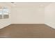 Simple living room with neutral walls and tile flooring at 16006 W Cottontail Ln, Surprise, AZ 85387