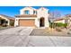 Two-story house with tan exterior, two-car garage, and neatly landscaped front yard at 25954 W Sequoia Dr, Buckeye, AZ 85396