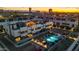 Stunning aerial view of modern townhomes with a sparkling pool, manicured landscaping, and a vibrant urban setting at sunset at 377 E Windsor Ave # 3, Phoenix, AZ 85004