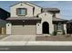 Charming two-story home with a two-car garage, landscaped front yard, and an arched entryway at 6732 W Coles Rd, Laveen, AZ 85339