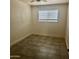 A bright bedroom with neutral walls, tile floors, and a window with blinds at 18202 N Cave Creek Rd # 107, Phoenix, AZ 85032