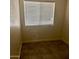 This bedroom features a window with blinds and neutral tile flooring at 18202 N Cave Creek Rd # 107, Phoenix, AZ 85032