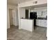 Bright kitchen with white cabinets, grey counters, and stainless steel sink offers modern amenities at 18202 N Cave Creek Rd # 107, Phoenix, AZ 85032