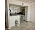 Bright kitchen features white cabinets and appliances, with a breakfast bar at 18202 N Cave Creek Rd # 107, Phoenix, AZ 85032
