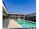 Community pool with crystal-clear water is surrounded by apartments and lush landscaping at 18202 N Cave Creek Rd # 107, Phoenix, AZ 85032