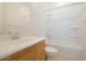 Well-lit bathroom showcasing a tub-shower combo and wood-trimmed vanity at 33337 N Maverick Mountain Trl, Queen Creek, AZ 85144