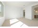 Bright bedroom with neutral carpet, great light, and access to the bathroom at 4799 W Flat Iron Ct, Queen Creek, AZ 85144