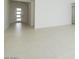 Bright entryway with white walls, neutral tile floors, and a modern front door at 4799 W Flat Iron Ct, Queen Creek, AZ 85144