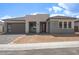 Charming single-story home boasting a modern elevation with a 2-car garage and desert landscaping at 4799 W Flat Iron Ct, Queen Creek, AZ 85144