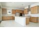 Bright kitchen featuring wooden cabinets, a white center island, and stainless steel appliances at 4799 W Flat Iron Ct, Queen Creek, AZ 85144