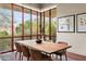 Dining room featuring large windows, art, and a dining table with seating for eight at 6301 N 51St Pl, Paradise Valley, AZ 85253
