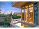 Modern home exterior features a small water feature, large picture windows, and desert landscaping at 6301 N 51St Pl, Paradise Valley, AZ 85253