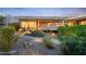 Modern home exterior featuring desert landscaping with accent lighting, and a concrete driveway at 6301 N 51St Pl, Paradise Valley, AZ 85253