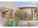 Home exterior featuring desert landscaping and an open breezeway leading to a three car garage at 6301 N 51St Pl, Paradise Valley, AZ 85253