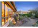 Home exterior featuring large windows, desert landscaping, and accent lighting along a walkway at 6301 N 51St Pl, Paradise Valley, AZ 85253