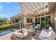 Outdoor living area with a covered patio, pool, comfortable seating, and desert landscaping at 6301 N 51St Pl, Paradise Valley, AZ 85253