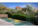 The backyard features a pool and sculpture with stunning desert mountain views at 6301 N 51St Pl, Paradise Valley, AZ 85253