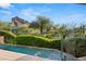 Beautiful backyard featuring pool, artistic water feature, desert landscaping, and mountain views at 6301 N 51St Pl, Paradise Valley, AZ 85253