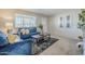 Living room featuring blue sofas, coffee table, and rug at 7243 E Portland St, Scottsdale, AZ 85257