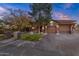 House exterior showcasing stone accents and a wooden garage door at 10042 S Greenfield Rd, Gilbert, AZ 85234