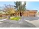 House exterior featuring stone facade and two-car garage at 10042 S Greenfield Rd, Gilbert, AZ 85234