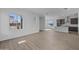 Open concept living room and kitchen with wood-look flooring at 26428 N 22Nd Ave, Phoenix, AZ 85085