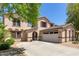 Two-story house with a three-car garage and mature landscaping at 18390 W Hayden Dr, Surprise, AZ 85374