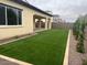 The backyard features pristine artificial turf and low-maintenance landscaping at 2134 W Rowel Rd, Phoenix, AZ 85085