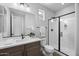 Modern bathroom featuring a glass-enclosed shower, stylish vanity, and neutral color scheme at 2134 W Rowel Rd, Phoenix, AZ 85085