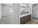 A bathroom with a large vanity, marble countertop, and a walk-in shower at 2134 W Rowel Rd, Phoenix, AZ 85085