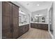 A spacious bathroom with a double sink vanity, framed mirrors and a glass walk-in shower at 2134 W Rowel Rd, Phoenix, AZ 85085