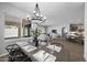 A dining room flows into a living room and kitchen with a large window view at 2134 W Rowel Rd, Phoenix, AZ 85085