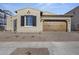 Tan house with brown garage door and landscaping at 2134 W Rowel Rd, Phoenix, AZ 85085