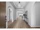 Elegant foyer featuring arched doorways, decorative lighting, and stylish wood-look flooring at 2134 W Rowel Rd, Phoenix, AZ 85085