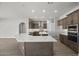 Modern kitchen with large island and wood cabinets at 2134 W Rowel Rd, Phoenix, AZ 85085