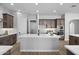 Open concept kitchen with an island and stainless steel appliances offers a modern design with an adjoining dining area at 2134 W Rowel Rd, Phoenix, AZ 85085