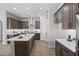 A modern kitchen featuring stylish cabinets, an island with seating, and stainless steel appliances with an open layout at 2134 W Rowel Rd, Phoenix, AZ 85085