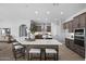 Gourmet kitchen with a large island, dark cabinets, and stainless steel appliances, perfect for cooking and entertaining at 2134 W Rowel Rd, Phoenix, AZ 85085