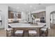 Bright kitchen with double islands, stainless steel range hood, modern fixtures and a view to the living space at 2134 W Rowel Rd, Phoenix, AZ 85085