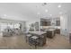 Expansive open-concept living space with seating at the kitchen island and a comfortable living room with neutral decor at 2134 W Rowel Rd, Phoenix, AZ 85085