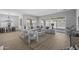 Bright living room with large windows, neutral décor, and wood-look floors, open to dining area at 2134 W Rowel Rd, Phoenix, AZ 85085